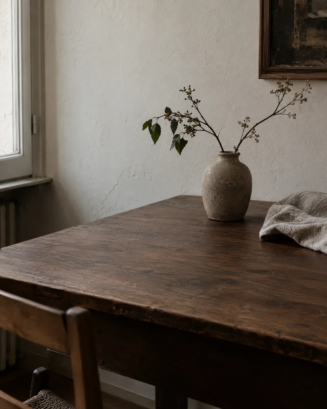 Wooden tabletop and ceramic vase in natural light